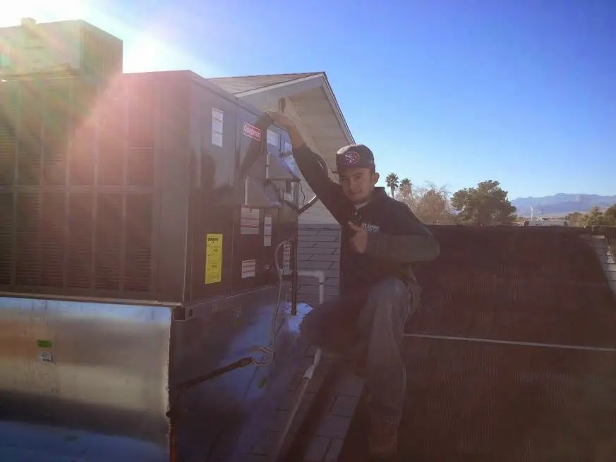 HVAC technician performing Boiler Repair on a rooftop unit in Conway